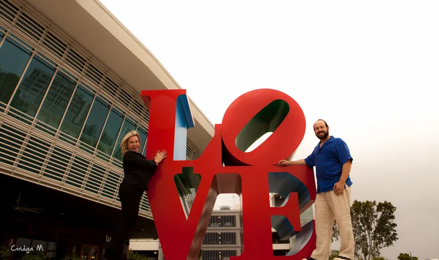 Betty and Marcelo standing beside the LOVE sculpture